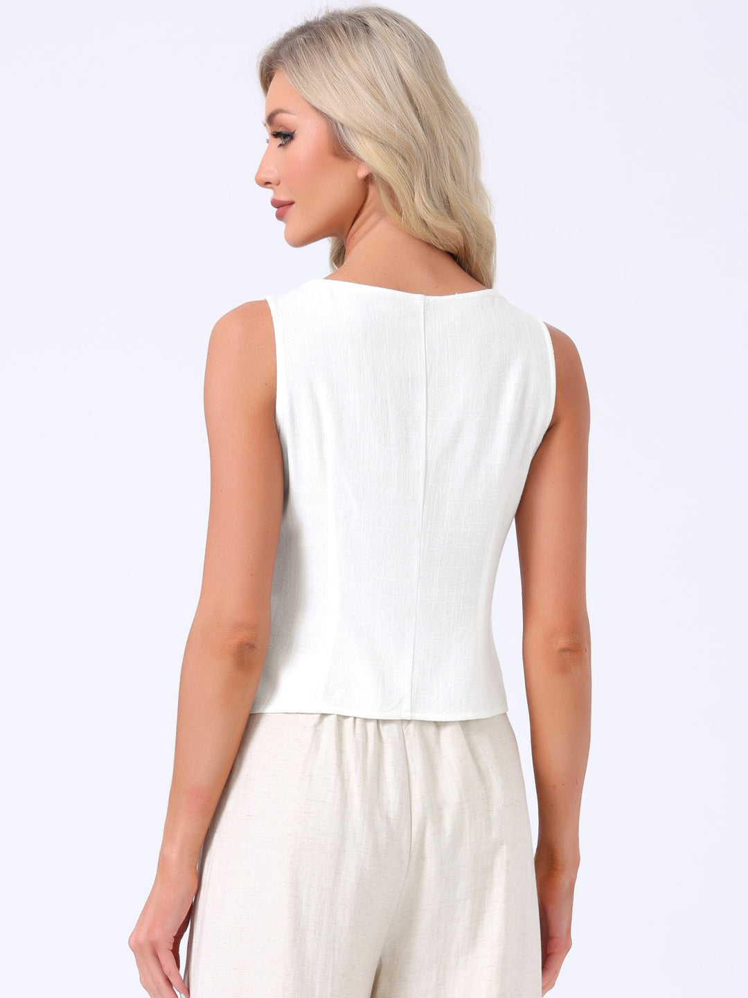 Damska bluzka bez rękawów z asymetrycznym dołem i guzikami